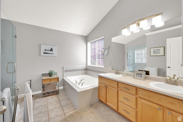 full bath featuring lofted ceiling, a sink, double vanity, and a stall shower