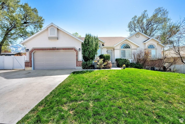 ranch-style home with concrete driveway, fence, an attached garage, a front yard, and stucco siding