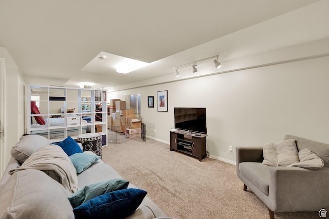 living area with light carpet and baseboards