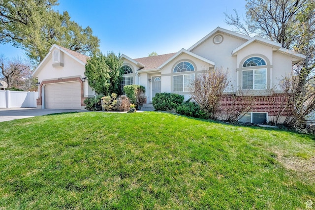 ranch-style home featuring concrete driveway, fence, a front yard, a garage, and stucco siding