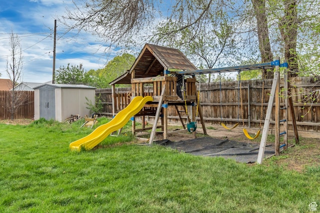 view of playground featuring an outbuilding, a lawn, a shed, and a fenced backyard
