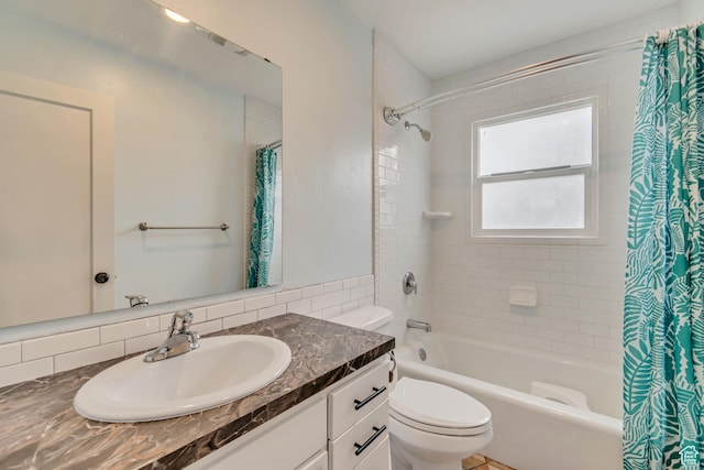 full bath featuring vanity, shower / bathtub combination with curtain, and toilet