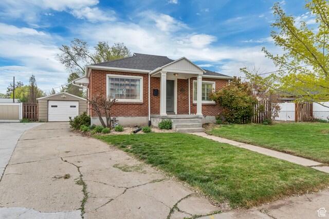 bungalow-style house with concrete driveway, fence, brick siding, a garage, and an outdoor structure
