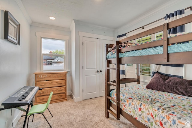 carpeted bedroom featuring baseboards, a closet, ornamental molding, and multiple windows