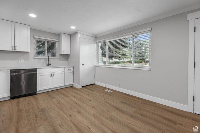1210 W 4365 S Unit 3A, Taylorsville, UT 84123 - kitchen with dishwashing machine, a sink, white cabinetry, baseboards, and ornamental molding