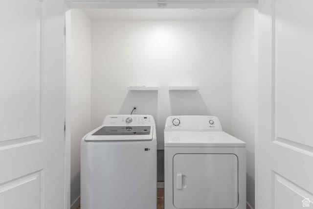 laundry room with washing machine and clothes dryer and laundry area