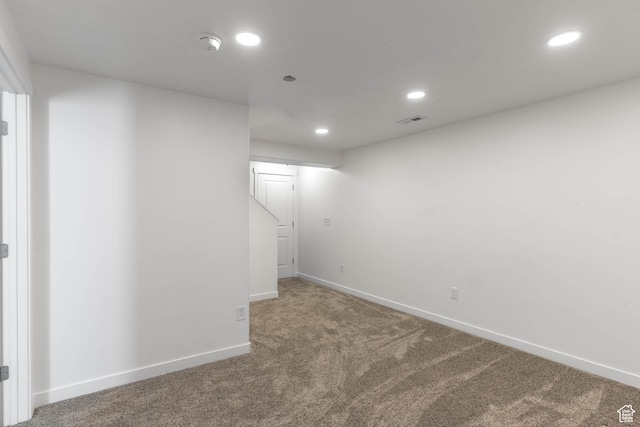 finished below grade area featuring recessed lighting, carpet, visible vents, and baseboards