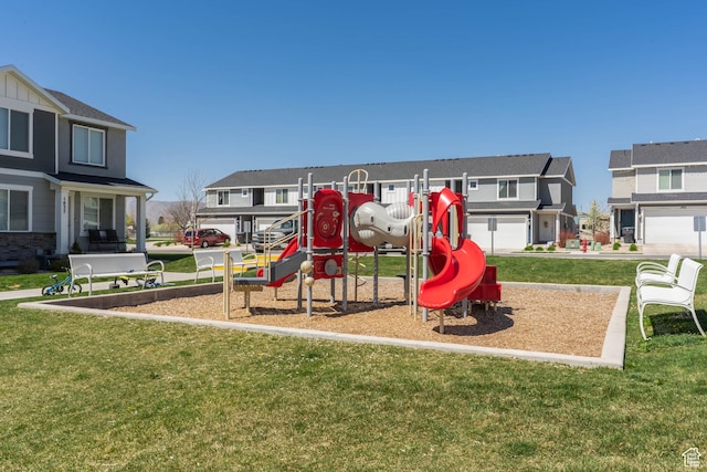 communal playground with a yard and a residential view