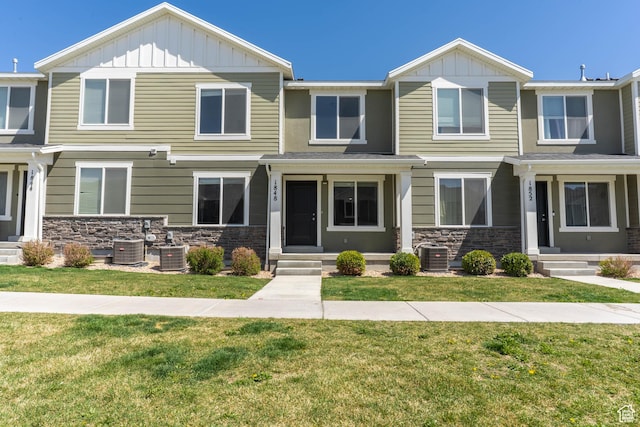 view of front of home featuring board and batten siding, entry steps, and stone siding