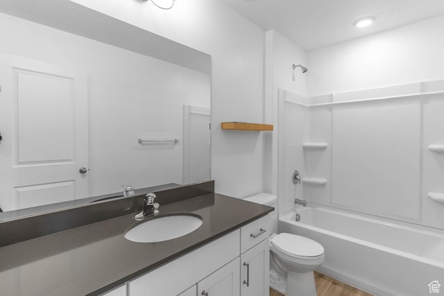 full bath with toilet, vanity, wood finished floors, and shower / bathing tub combination