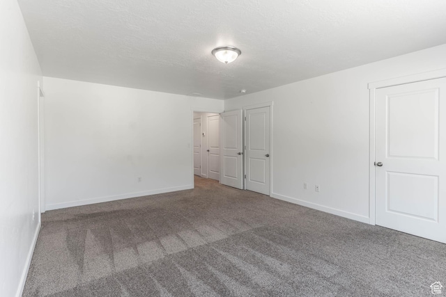 unfurnished bedroom featuring baseboards and carpet flooring