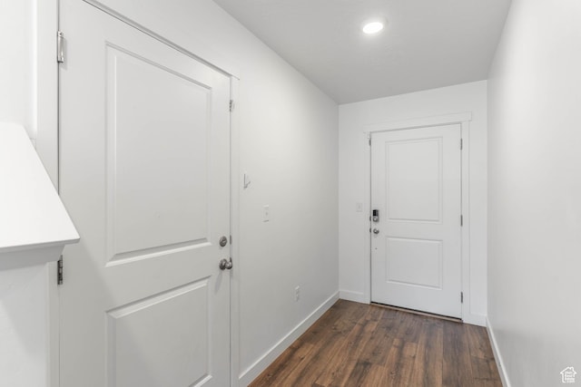 doorway to outside featuring baseboards, dark wood-style floors, and recessed lighting