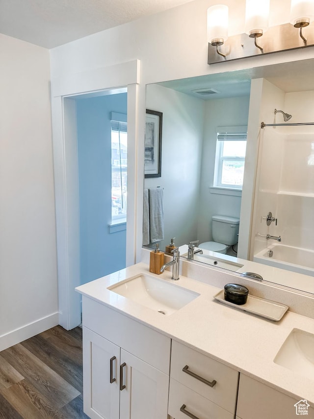 627 W 575 N Unit 545, Smithfield, UT 84335 - full bath with wood finished floors, vanity, tub / shower combination, toilet, and visible vents
