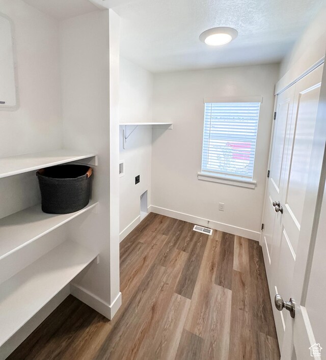 627 W 575 N Unit 545, Smithfield, UT 84335 - laundry area with electric dryer hookup, wood finished floors, visible vents, and laundry area