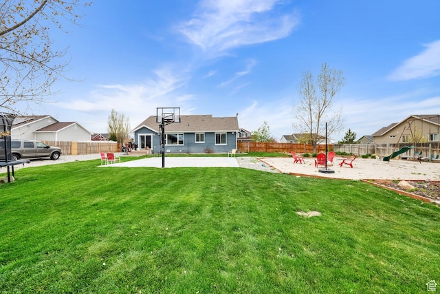 4104 Rose Springs Rd Unit 406, Erda, UT 84074 - back of property with a patio area, a lawn, a fenced backyard, and a playground
