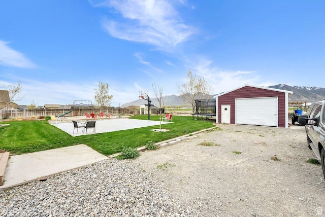 4104 Rose Springs Rd Unit 406, Erda, UT 84074 - view of yard with a playground, fence, an outdoor structure, a mountain view, and a trampoline