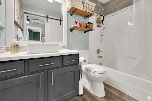 4104 Rose Springs Rd Unit 406, Erda, UT 84074 - full bathroom with backsplash, wood finished floors, toilet, vanity, and shower / bath combo