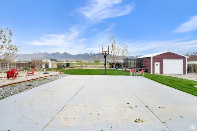 4104 Rose Springs Rd Unit 406, Erda, UT 84074 - view of patio / terrace featuring fence, a detached garage, an outdoor structure, and a mountain view