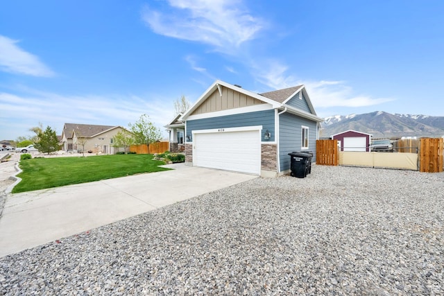 4104 Rose Springs Rd Unit 406, Erda, UT 84074 - view of property exterior with a lawn, fence, stone siding, and board and batten siding