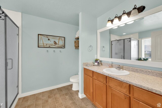 4104 Rose Springs Rd Unit 406, Erda, UT 84074 - bathroom featuring toilet, baseboards, vanity, and a stall shower
