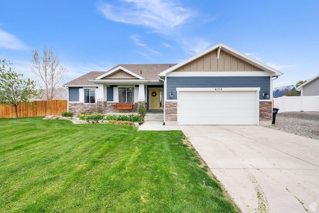 craftsman-style house featuring concrete driveway, an attached garage, fence, and a front lawn