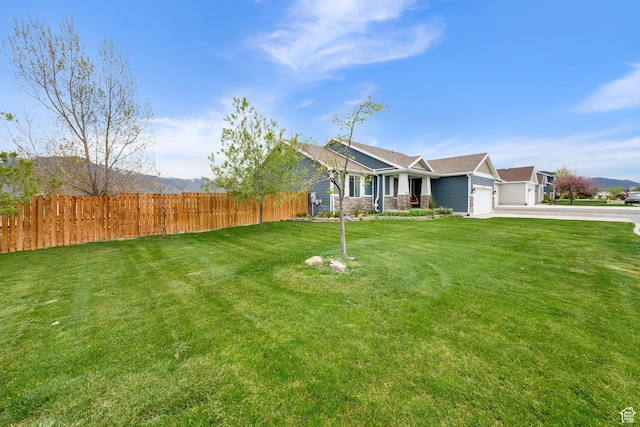 4104 Rose Springs Rd Unit 406, Erda, UT 84074 - exterior space featuring fence, an attached garage, a front lawn, and driveway