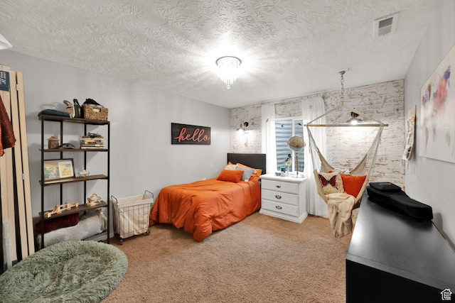 4104 Rose Springs Rd Unit 406, Erda, UT 84074 - bedroom featuring brick wall, visible vents, carpet, and a textured ceiling