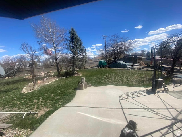 view of community featuring fence, a patio area, and a yard