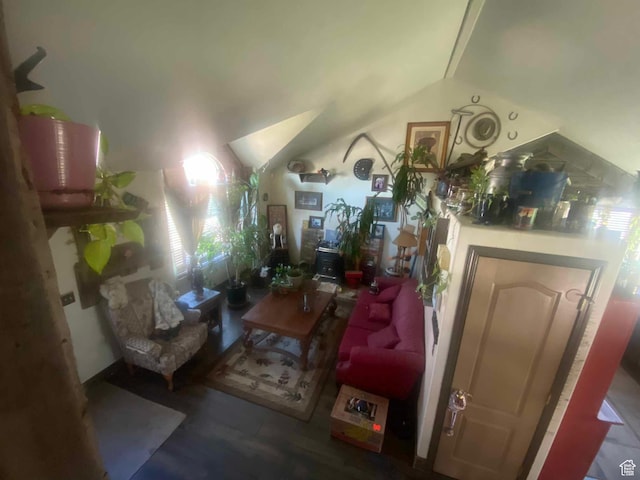 living room with wood finished floors and vaulted ceiling