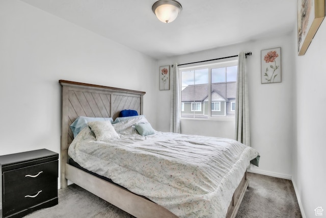 carpeted bedroom featuring baseboards