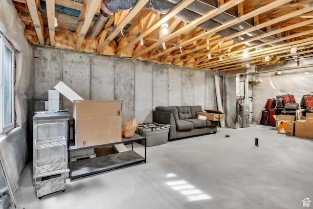 unfinished basement featuring heating unit