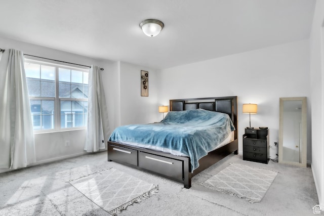 bedroom with baseboards and carpet