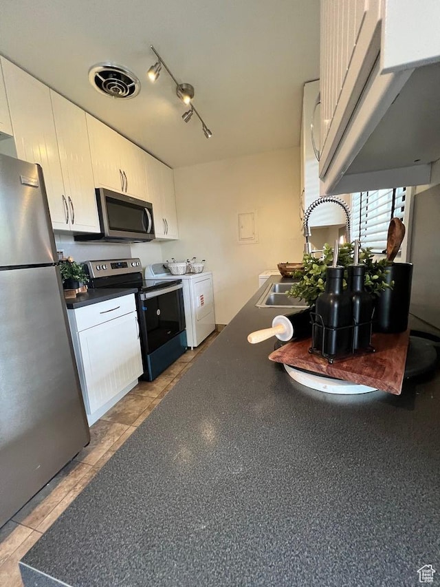 635 N 1200 W Unit A-306, Salt Lake City, UT 84116 - kitchen with dark countertops, visible vents, a sink, washer / dryer, and appliances with stainless steel finishes
