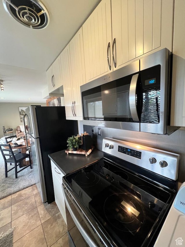 635 N 1200 W Unit A-306, Salt Lake City, UT 84116 - kitchen featuring white cabinets, stainless steel appliances, and light tile patterned floors