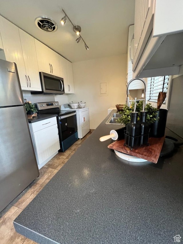 635 N 1200 W Unit A-306, Salt Lake City, UT 84116 - kitchen featuring dark countertops, visible vents, white cabinetry, washer / clothes dryer, and appliances with stainless steel finishes