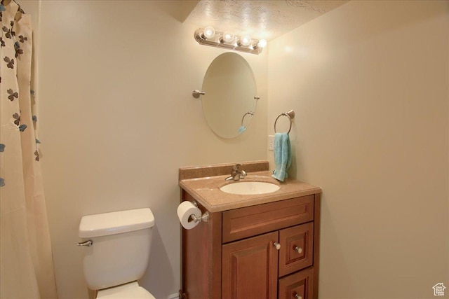 full bath featuring vanity and toilet