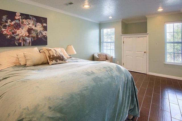 bedroom with recessed lighting, visible vents, baseboards, and multiple windows