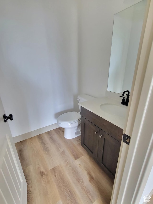5682 W 7220 S, West Jordan, UT 84081 - bathroom featuring wood finished floors, vanity, and toilet