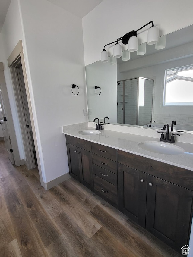 5682 W 7220 S, West Jordan, UT 84081 - bathroom with double vanity, a stall shower, wood finished floors, and a sink
