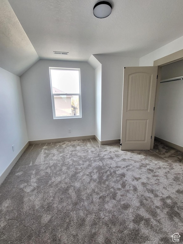 5682 W 7220 S, West Jordan, UT 84081 - additional living space featuring lofted ceiling, visible vents, carpet, and a textured ceiling