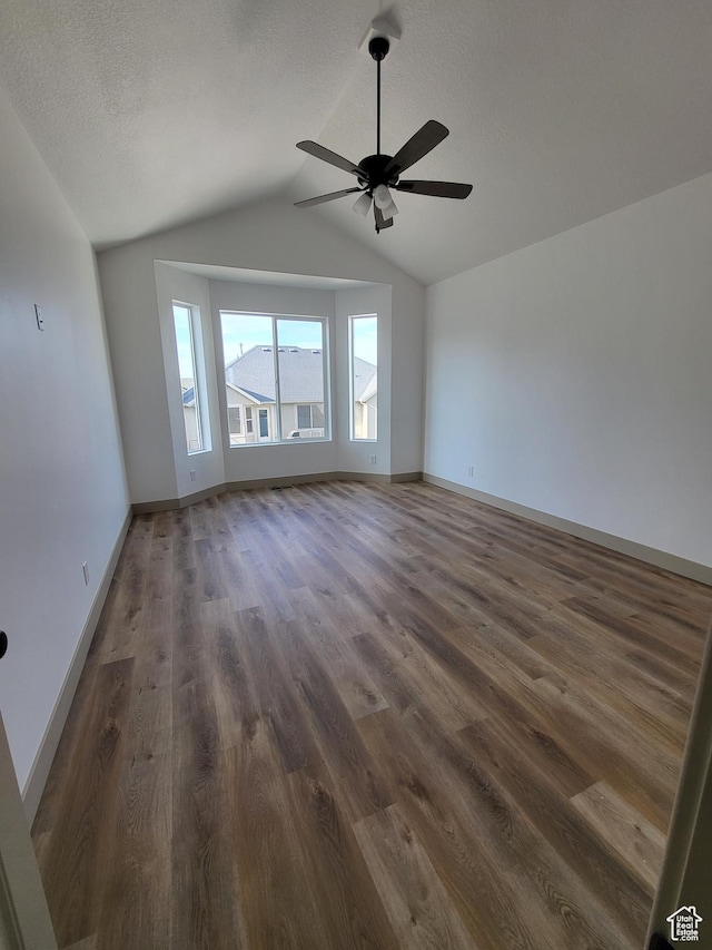 5682 W 7220 S, West Jordan, UT 84081 - unfurnished room with a textured ceiling, vaulted ceiling, baseboards, a ceiling fan, and dark wood-type flooring