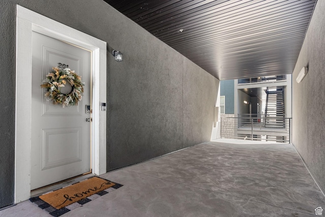 doorway to property featuring stucco siding