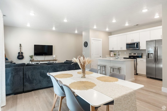 dining room featuring recessed lighting, visible vents, and light wood finished floors