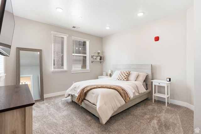 bedroom with light colored carpet, baseboards, visible vents, and recessed lighting