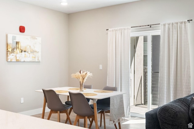 dining room featuring wood finished floors and baseboards