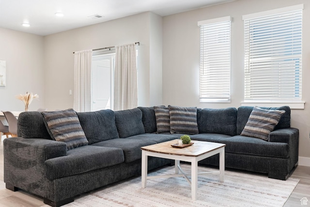 living room featuring visible vents and light wood-style flooring