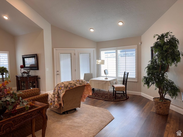 living area with recessed lighting, lofted ceiling, dark wood-style flooring, and baseboards