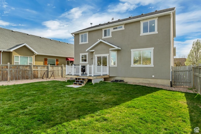 8459 N Western Gailes Dr, Eagle Mountain, UT 84005 - rear view of property featuring a fenced backyard, a yard, a deck, and stucco siding