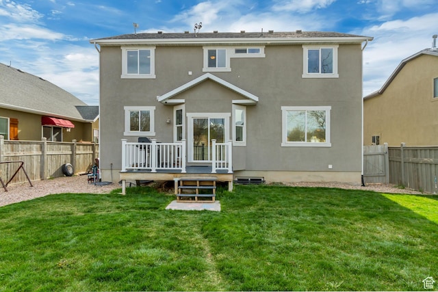 8459 N Western Gailes Dr, Eagle Mountain, UT 84005 - back of property with a lawn, a fenced backyard, and a deck