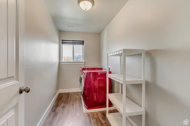 8459 N Western Gailes Dr, Eagle Mountain, UT 84005 - laundry area featuring wood finished floors, washer and clothes dryer, laundry area, baseboards, and visible vents